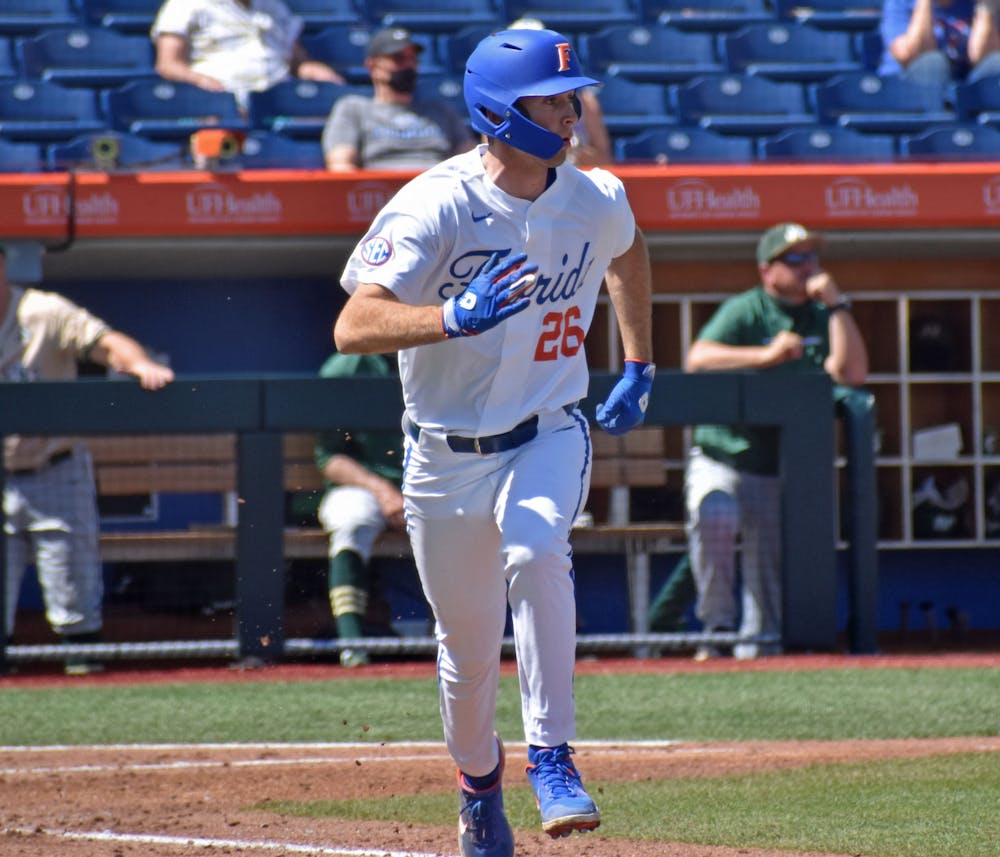 <p>Florida&#x27;s Sterlin Thompson eyes a hit and runs down the first base line against Jacksonville on March 14, 2021.</p>