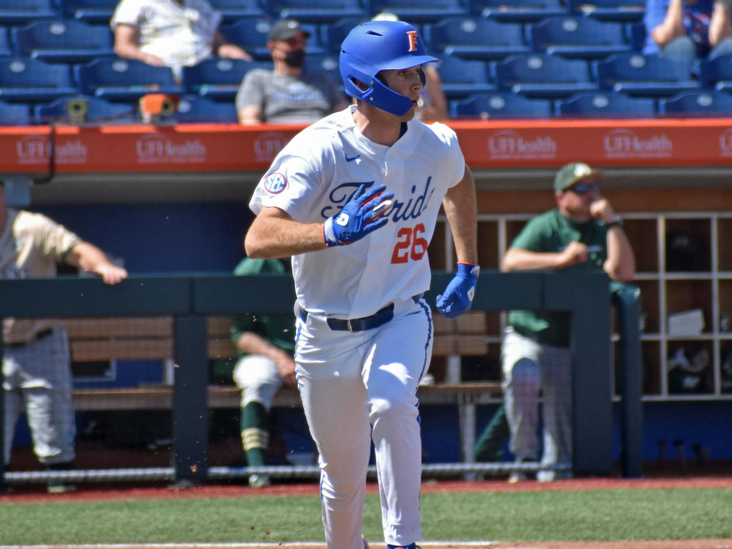 Florida&#x27;s Sterlin Thompson eyes a hit and runs down the first base line against Jacksonville on March 14, 2021. The Gators fell in the final game of the SEC Tournament Sunday to Tennessee.