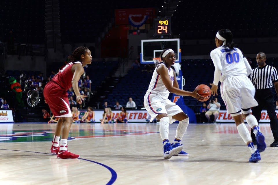 UF guard Dyandria Anderson passes the ball to teammate Delicia Washington during Florida's 57-53 win over Arkansas on Feb. 9, 2017, in the O'Connell Center.