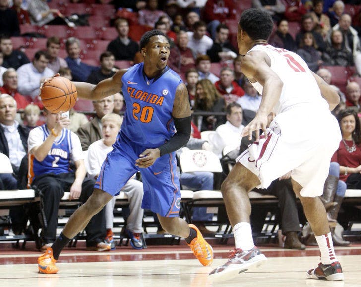 Michael&nbsp;Frazier II (20) is pressured by Alabama’s Algie Key (0) during the No. 6 Gators’ 68-62 win against the Crimson Tide in Coleman Coliseum in Tuscaloosa, Ala., on Thursday. Frazier scored 18 points against Alabama.