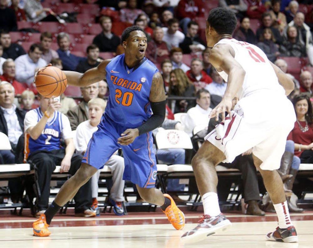 <p>Michael&nbsp;Frazier II (20) is pressured by Alabama’s Algie Key (0) during the No. 6 Gators’ 68-62 win against the Crimson Tide in Coleman Coliseum in Tuscaloosa, Ala., on Thursday. Frazier scored 18 points against Alabama.</p>