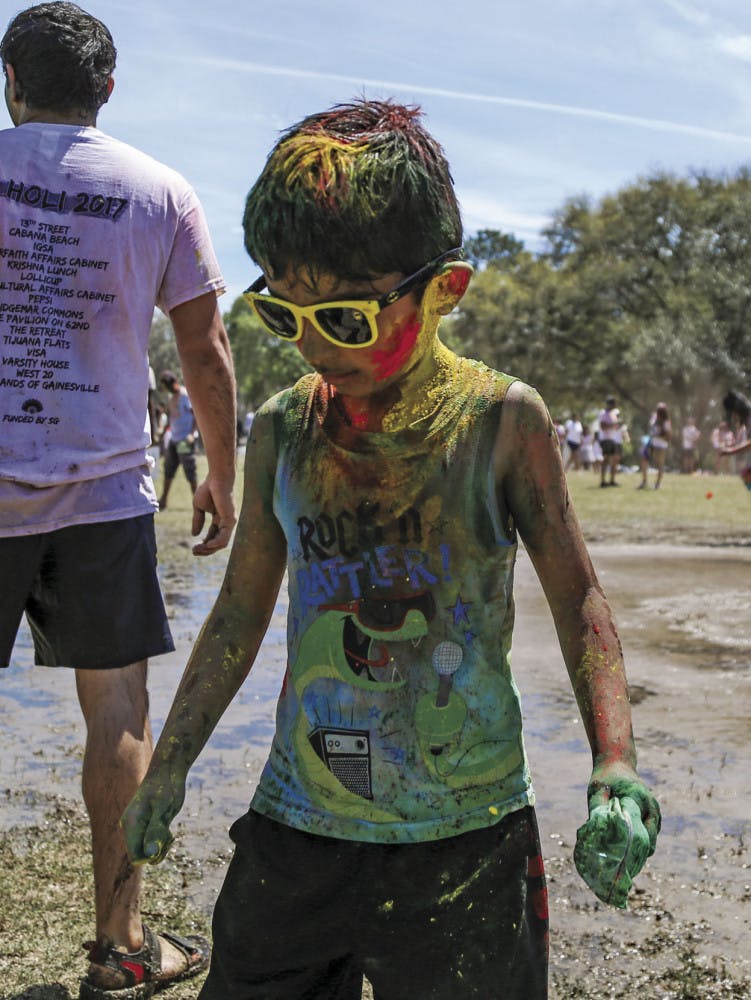 Tanish Vyas, 6, originally from India, celebrates Holi with his family on Sunday afternoon during the UF Holi Festival of Colors, organized by the Indian Student Association and Student Government.
&nbsp;