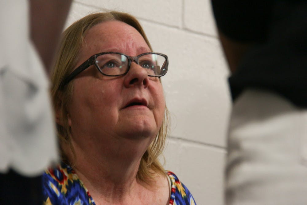 <p>Felicia Cruce listens as people tell her stories of her recently deceased son, Joshua Hildebrandt, at his memorial held on Thursday at the entomology hall where he used to work.</p>
