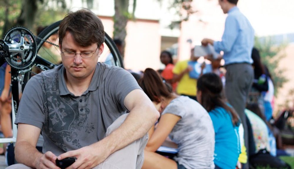 <p>Student Health Care Center clerk Donald Greist, 35, waits in line for tickets for first lady Michelle Obama. Obama will be speaking Monday in the Stephen C. O’Connell Center at 3:30 p.m.</p>