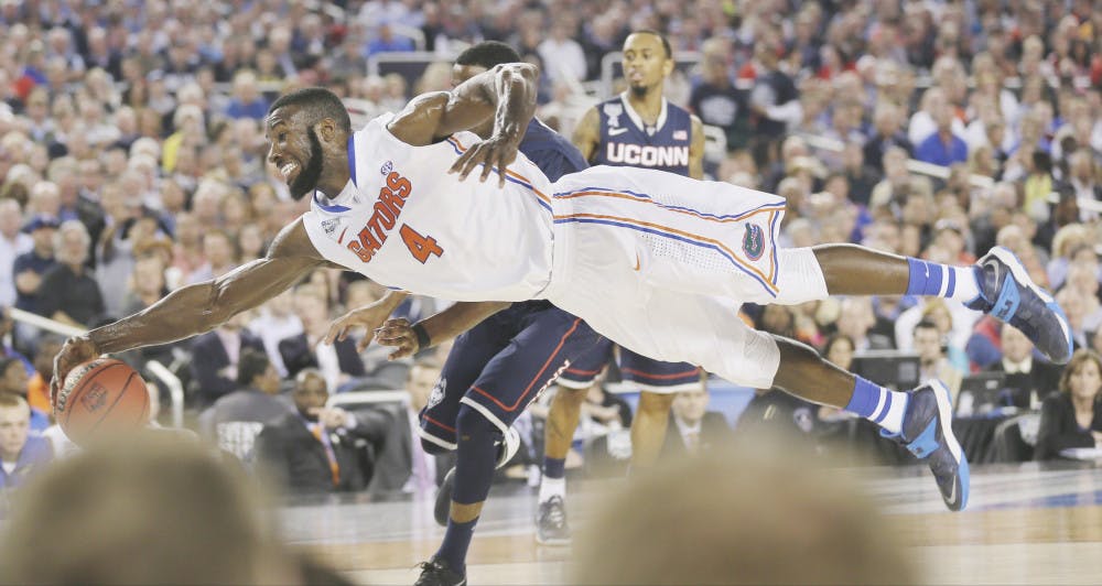 <p>Patric Young (4) goes after a loose ball during the second half of Florida’s 63-53 loss to Connecticut in the NCAA Final Four tournament on April 4 in Arlington, Texas. UF will face UConn on Jan. 3.</p>