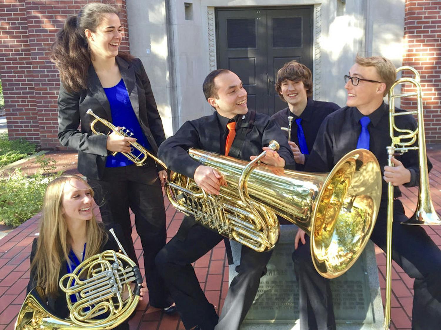 From left: Audrey Bridge, 20, Cara McDermott, 20, Ismael Sandoval, 21, Lucas Owen, 20, and Neal Romberg, 21, pose for a photo outside Century Tower. Together, the five form the Seven Cents Brass Quintet.