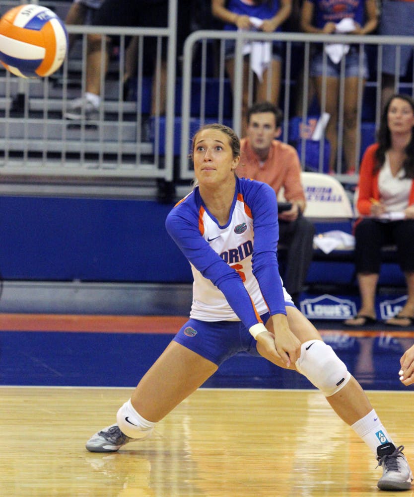 Mackenzie Dagostino squats during Florida’s three-set victory against Florida State on Tuesday in the O’Connell Center.
