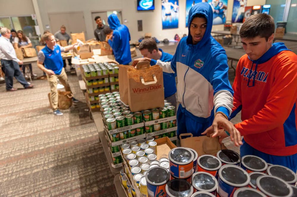 The University Athletic Association works with Grace Marketplace and Catholic Charities to find the homeless and families in need. On Monday, UF athletes filled 1,200 Winn-Dixie bags with Thanksgiving food — enough to feed 600 local families.