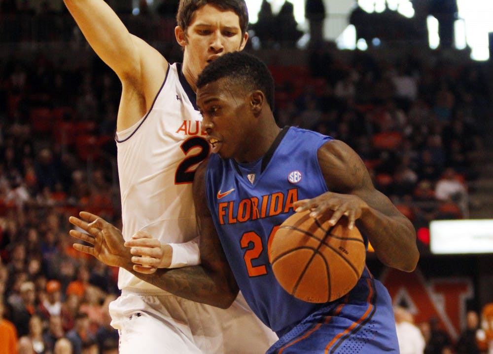 <p>Florida forward Casey Prather (24) drives past Auburn forward Alex Thompson during the No. 7 Gators' 68-61 win against the Tigers on Saturday in Auburn Arena.</p>