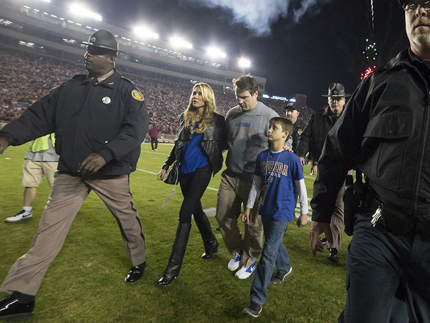 UF coach Will Muschamp walks off the field at Doak Campbell Stadium with his wife and kids following Florida's 24-19 loss to No. 3 Florida State on Saturday in Tallahassee.