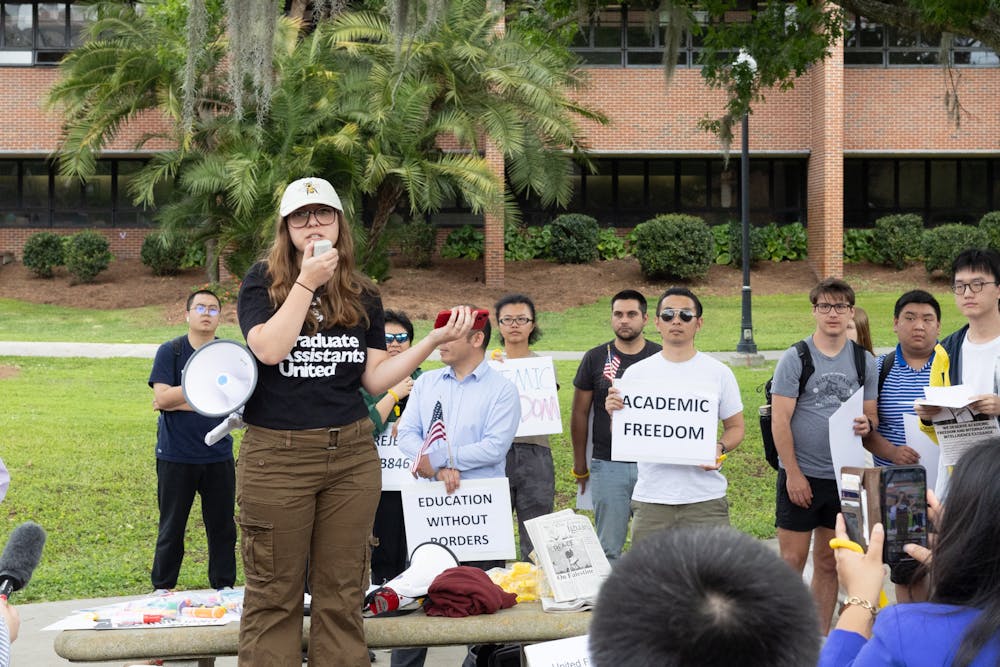 Protesters gather outside of the Reitz Union on Tuesday, March 26, 2024 to protest legislation blocking international students from Florida colleges and universities.