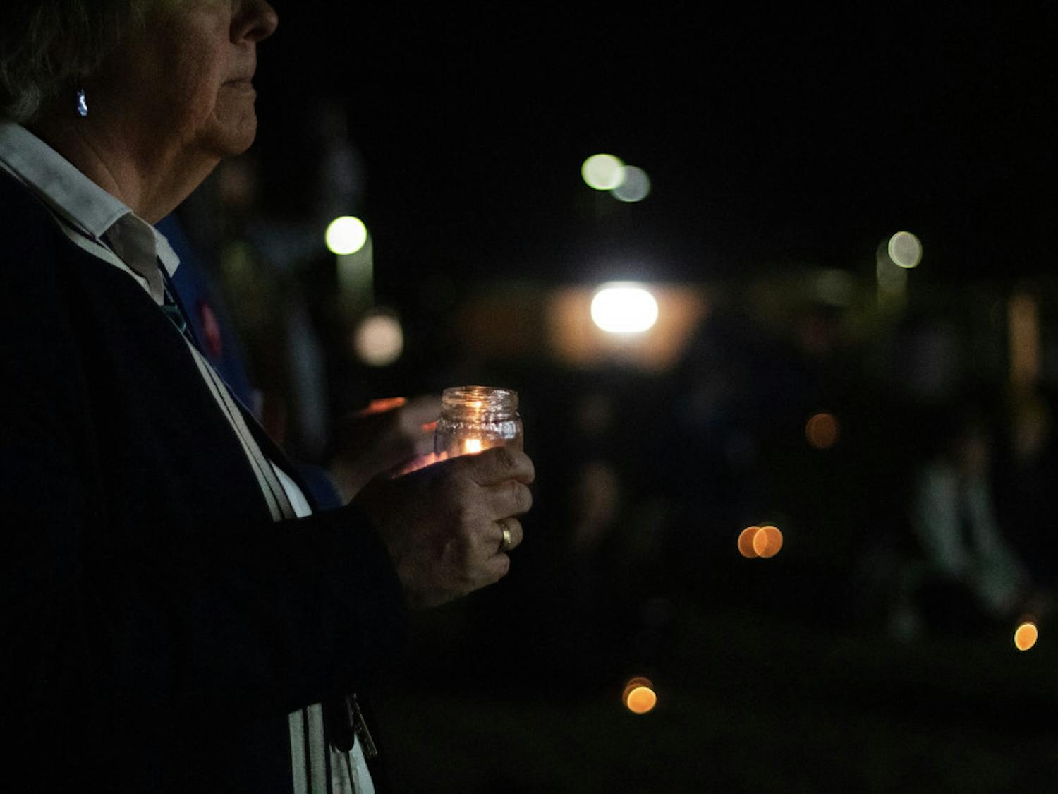 Flo Turcotte holds a candle for the vigil during the Transgender Day of Remembrance at Depot Park Wednesday night.
