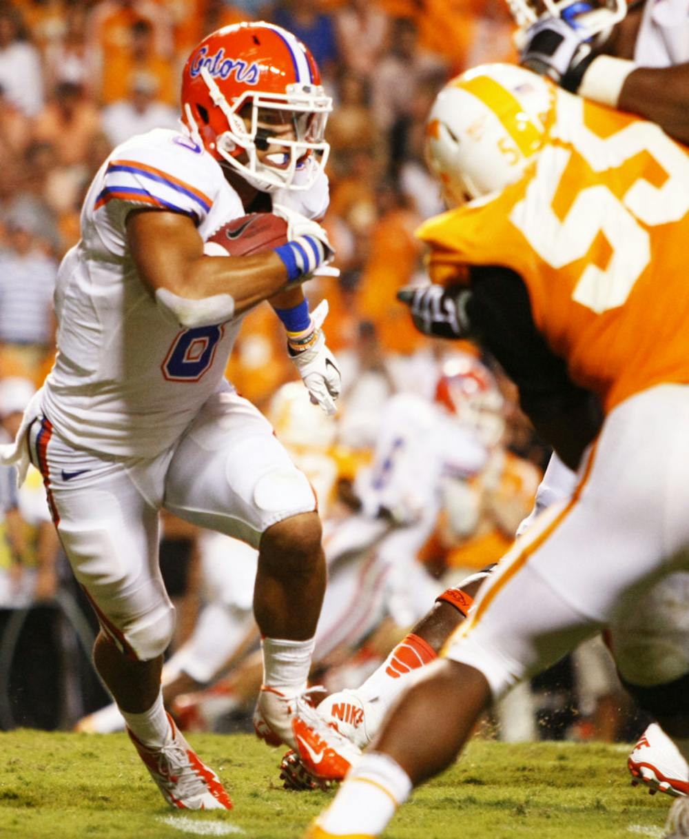 <p>Running back Trey Burton (8) sprints to the endzone in an 80-yard scamper for UF's second touchdown in its 37-20 victory over Tennessee on Saturday at Neyland Stadium.</p>