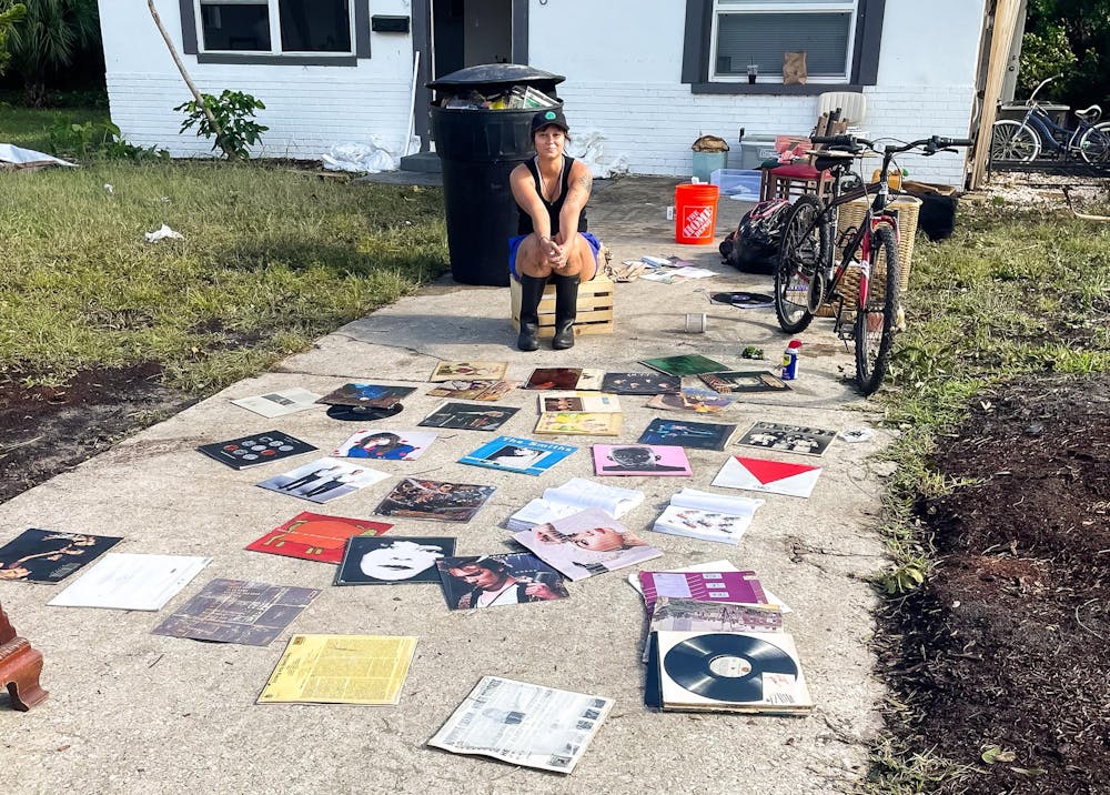 <p>Mackenzie Spiroff dries her record collection after Hurricane Helene flooded her St. Petersburg neighborhood. Photo courtesy of Mackenzie Spiroff.</p>