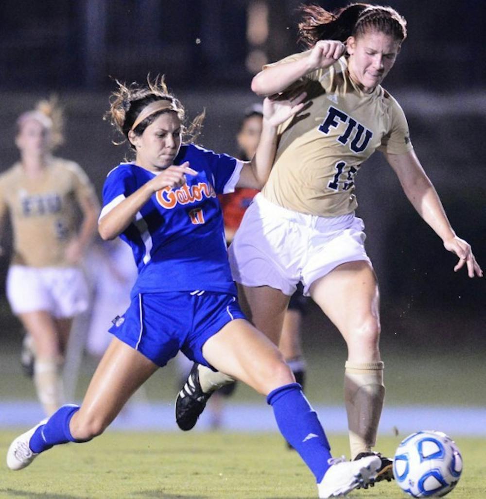 <p>Erika Tymrak (17) battles with Crystal McNamara (15) of Florida International University during Sunday nights win at James G. Pressly Stadium.</p>