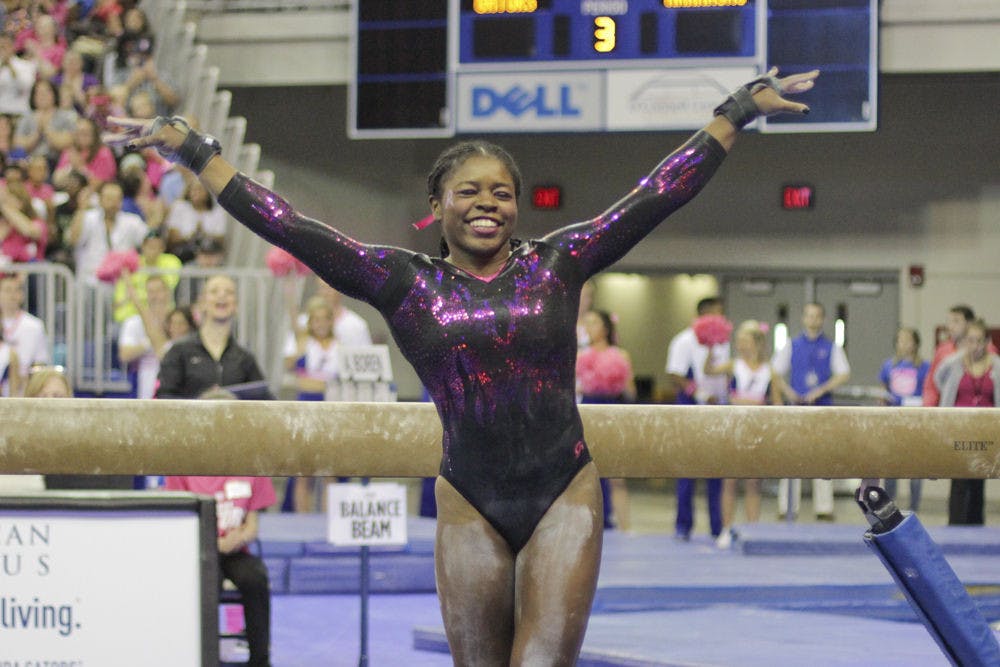 <p>Alicia Boren poses after completing her beam routine during Florida's win over Arkansas on Feb. 12, 2016, in the O'Connell Center.</p>