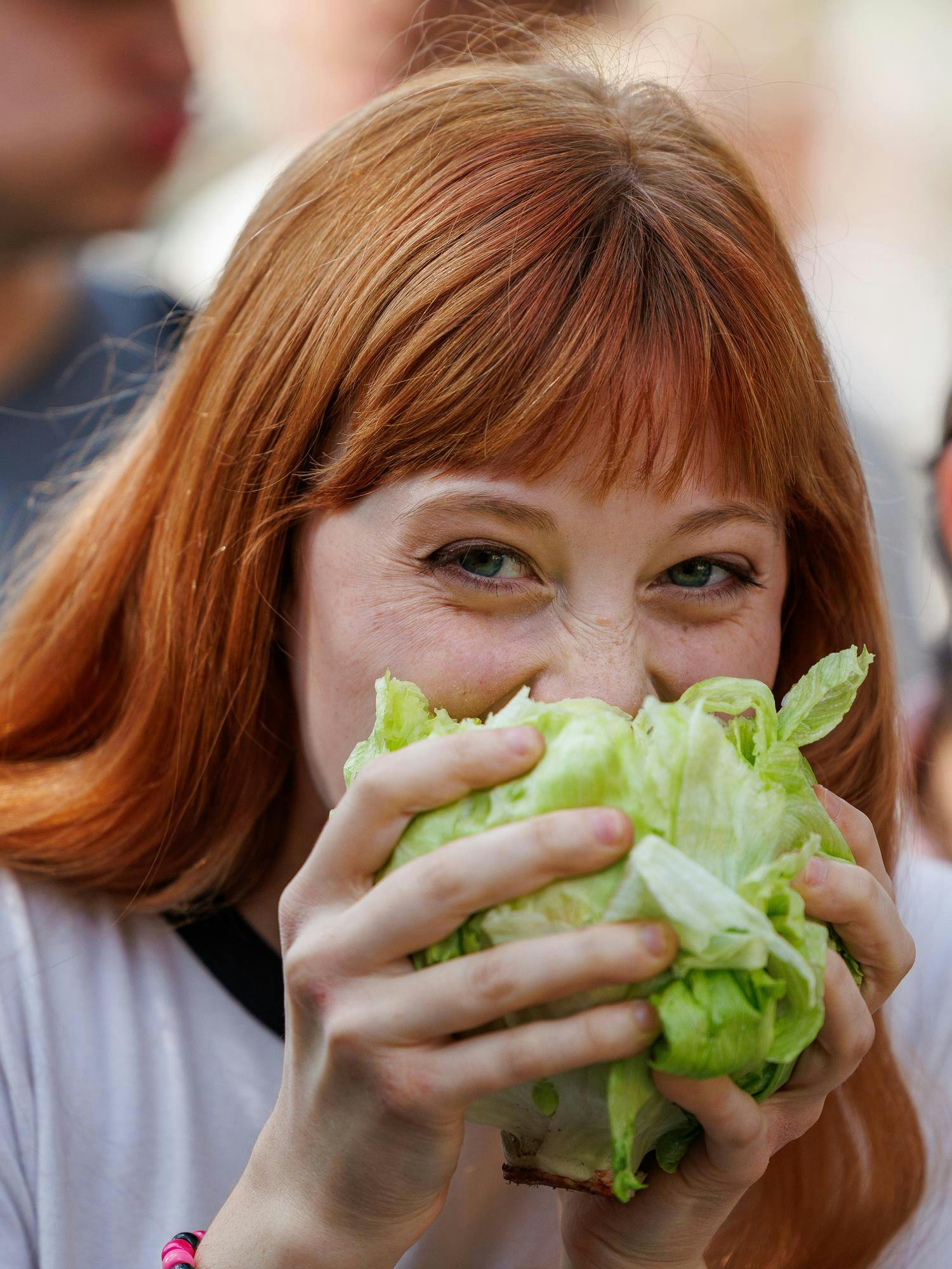 A University of Florida student takes a bite out of a head of lettuce, Thursday, Feb. 19, 2026, in Gainesville, Fla.