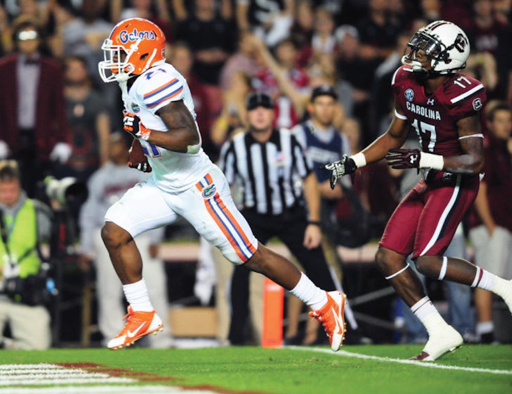 <p>Kelvin Taylor (21) scores a touchdown during Florida’s 19-14 loss to South Carolina on Nov. 16 at Williams-Brice Stadium in Columbia, S.C. Taylor rushed for 96 yards and two touchdowns in the Gators’ loss.</p>