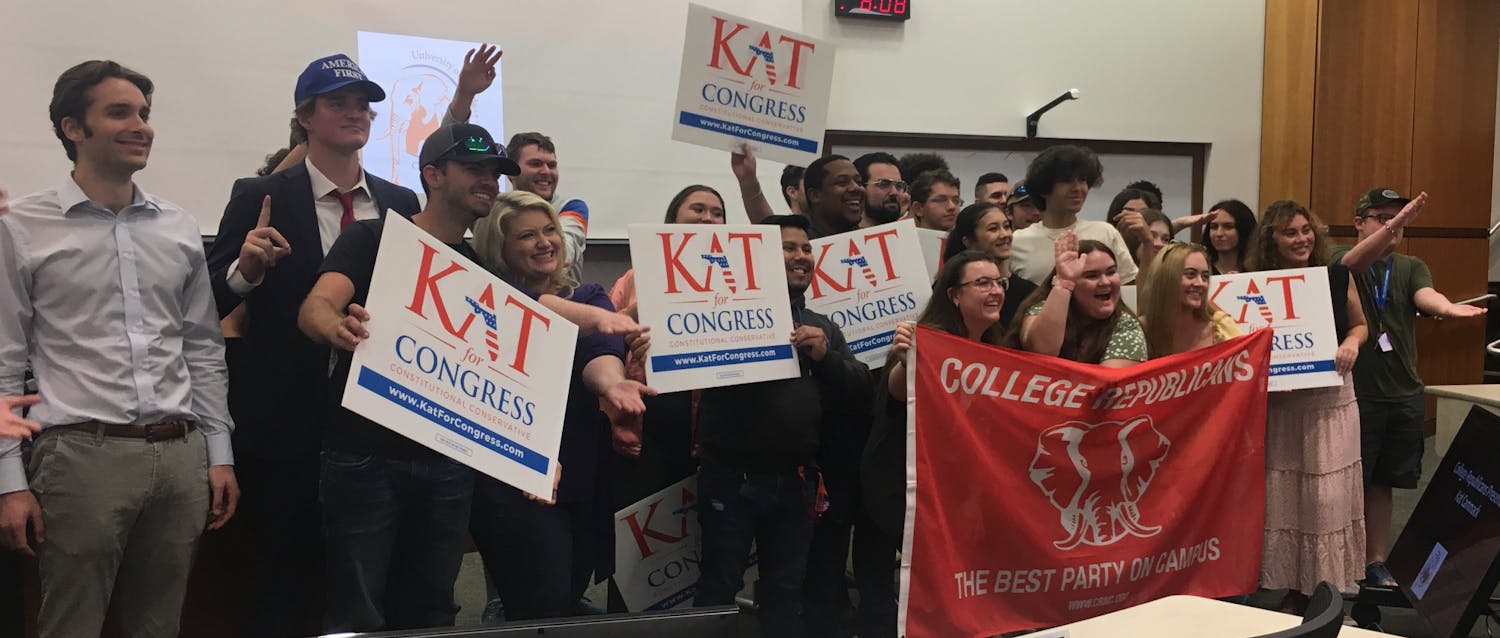 Rep. Kat Cammack poses with students from UF College Republicans Tuesday, October 4, 2022. She visited campus to touch on policy points and encourage students to become politically involved.﻿
