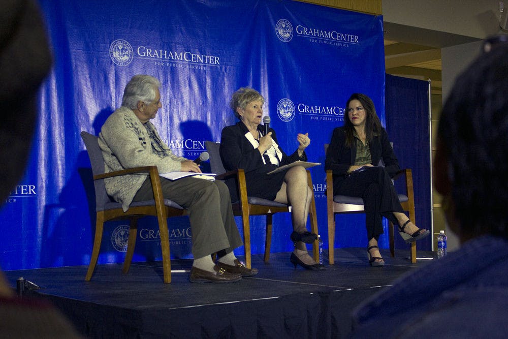 Kathleen Hawk, center, speaks with Adolfo Leyva de Varona and Lillian Guerra in Pugh Hall on Tuesday night at a discussion panel about the Mariel Boatlift of 1980.