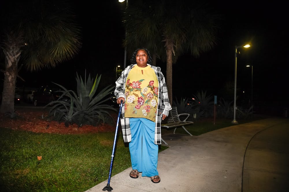 <p>Gator Corner worker Lucretia poses for a portrait on Friday, Nov. 15, 2024, at Depot Park in Gainesville, Fla.</p>