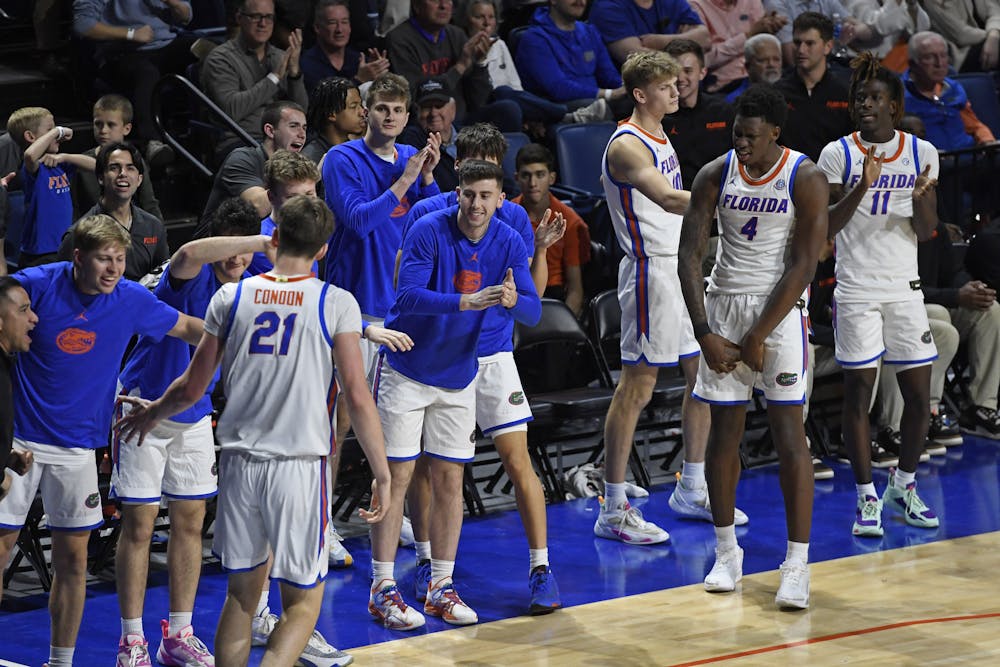 Florida men's basketball players celebrate on the bench in a win over Arkansas on Saturday, January 13, 2024. 