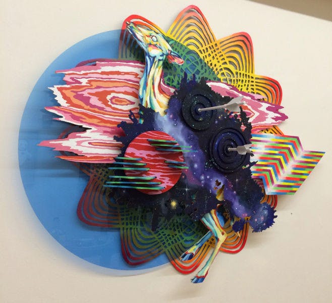 Hilary White displays her artwork at the Holographic Teeth exhibition inside Central Florida Office Plus. The exhibit opened Saturday, and White’s work will be displayed alongside Steven Speir’s through Jan. 31.