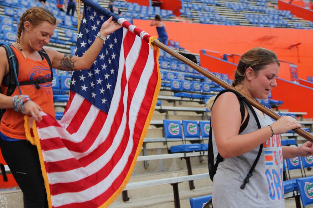Friends Erica Ross (left), a 26-year-old UF marine biology doctoral student and Evan Hill (right), a 24-year-old UF marine science alumna climb the stairs at Ben Hill Griffin Stadium in honor of the fallen servicemen and women of 9/11. Both women felt proud of each other for completing the climb.