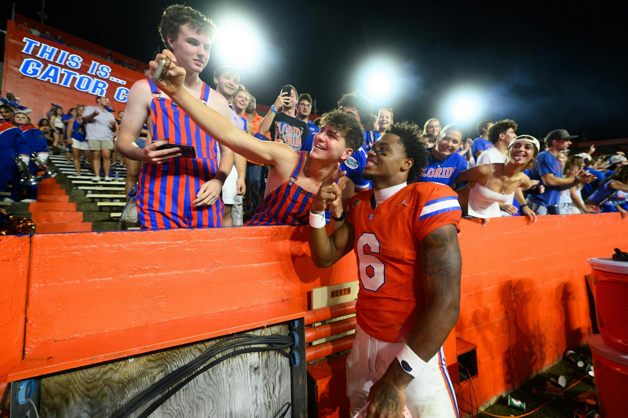Florida wide receiver Dallas Wilson (6) takes a picture with a fan after winning an NCAA college football game against Campbell, Saturday, Sept. 12, 2026, in Gainesville, Fla.