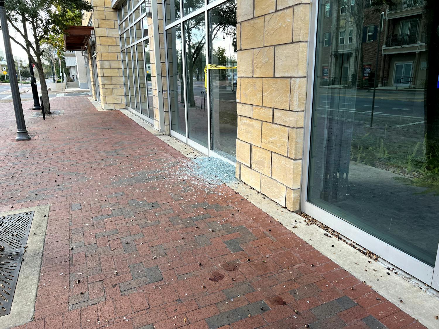 Shattered glass and blood on the sidewalk after Saturday's shooting