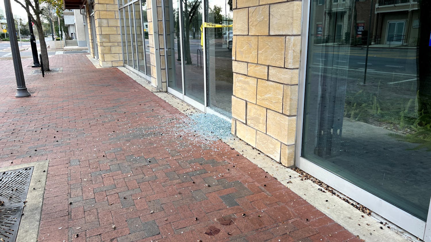 Shattered glass and blood on the sidewalk after Saturday's shooting