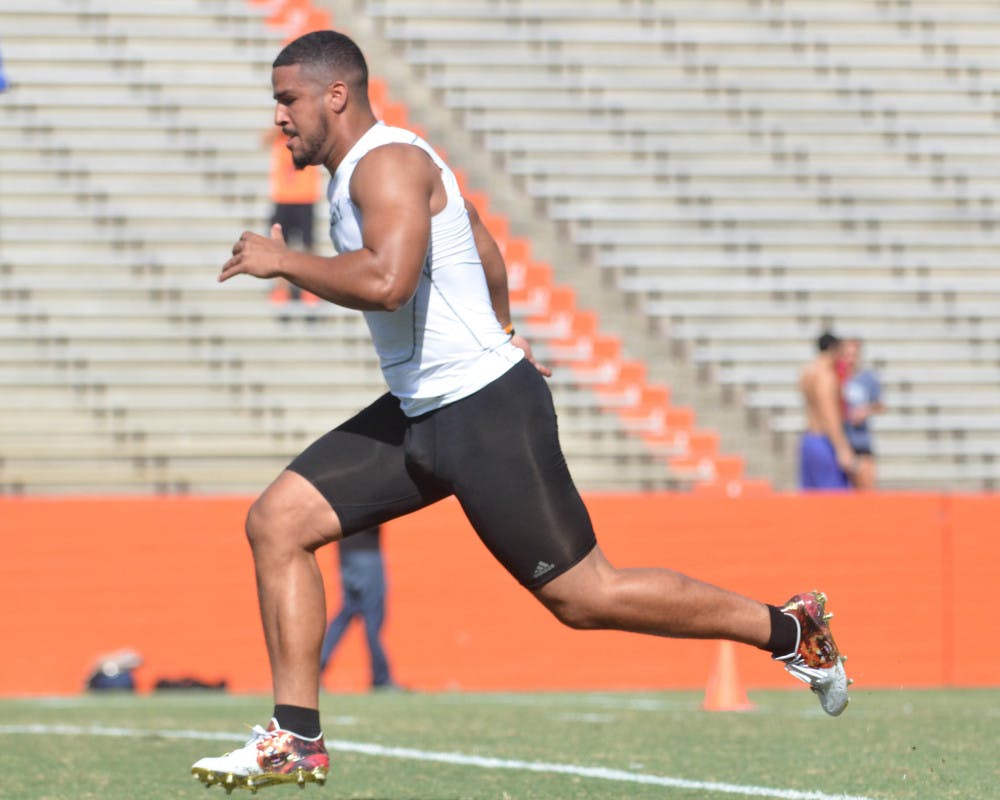 <p>Former UF tight end Clay Burton runs the 40-yard dash during UF's Pro Day on Tuesday at Ben Hill Griffin Stadium.</p>