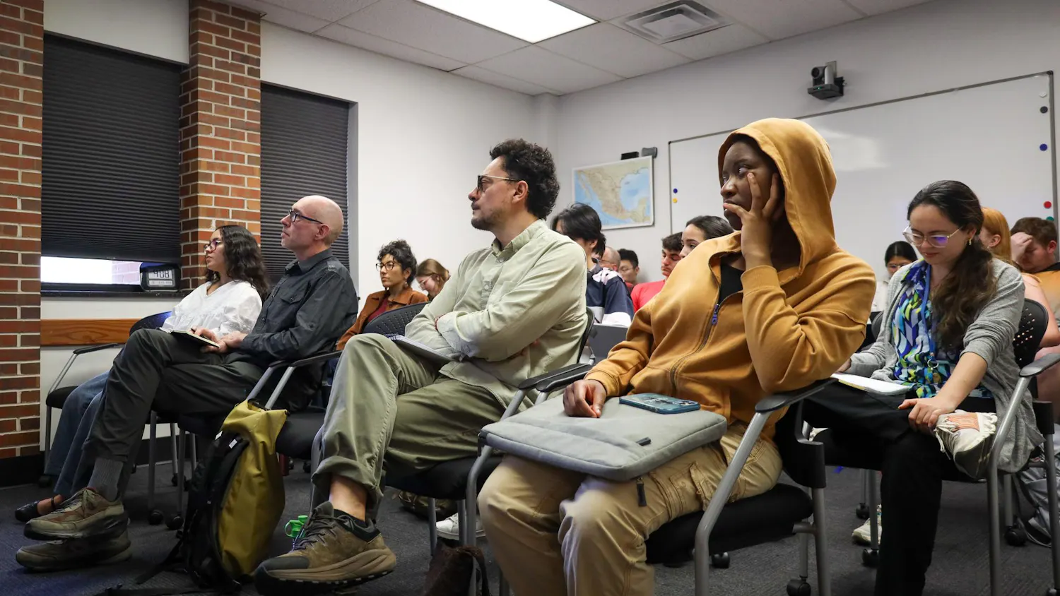 A crowd of about 20 listen to author Michael Deibert speak, Friday, March 27, 2026 at Grinter Hall in Gainesville, Fla.