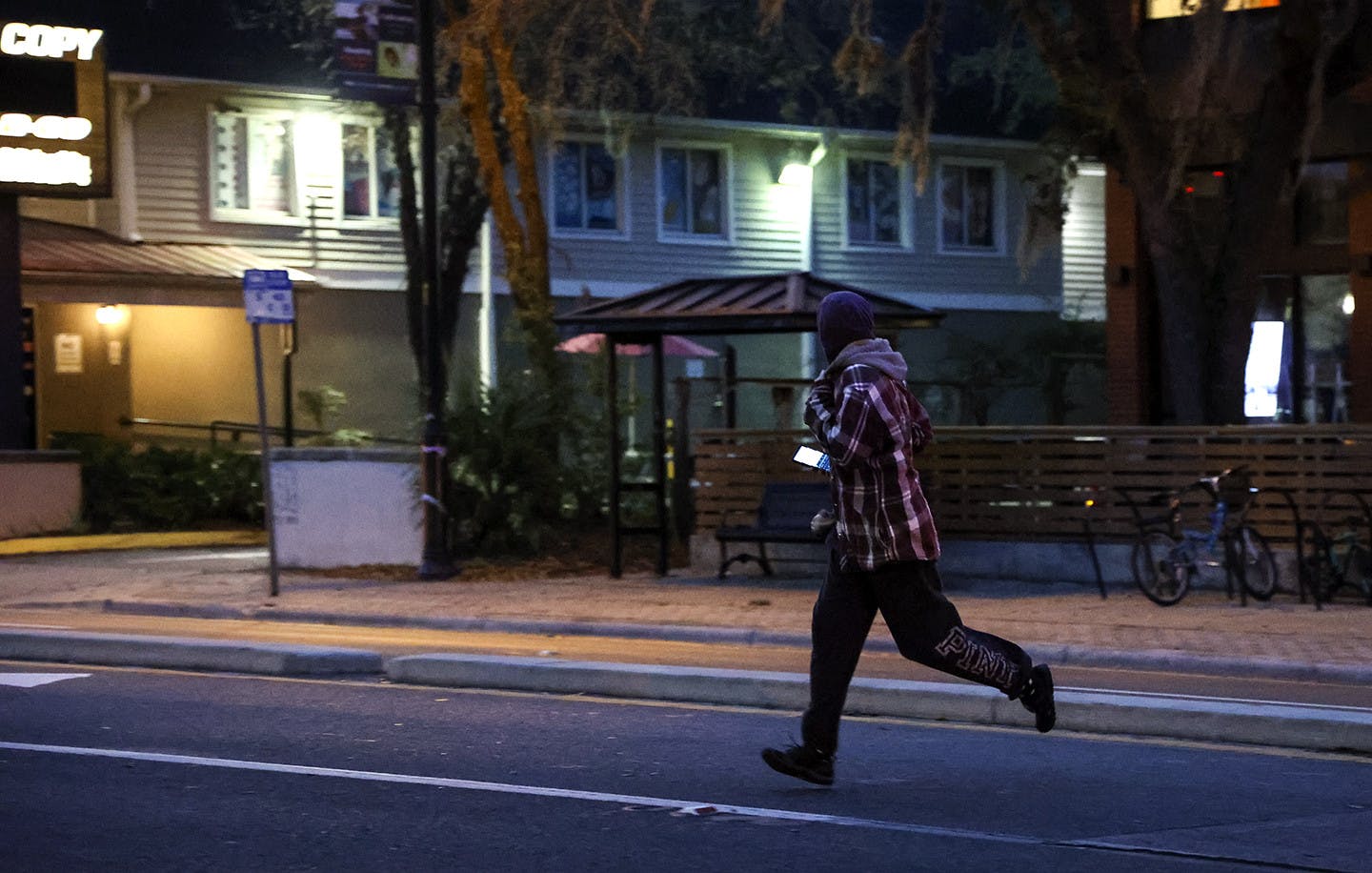 A pedestrian jaywalks across West University Avenue on Wednesday, Feb. 17, 2021.