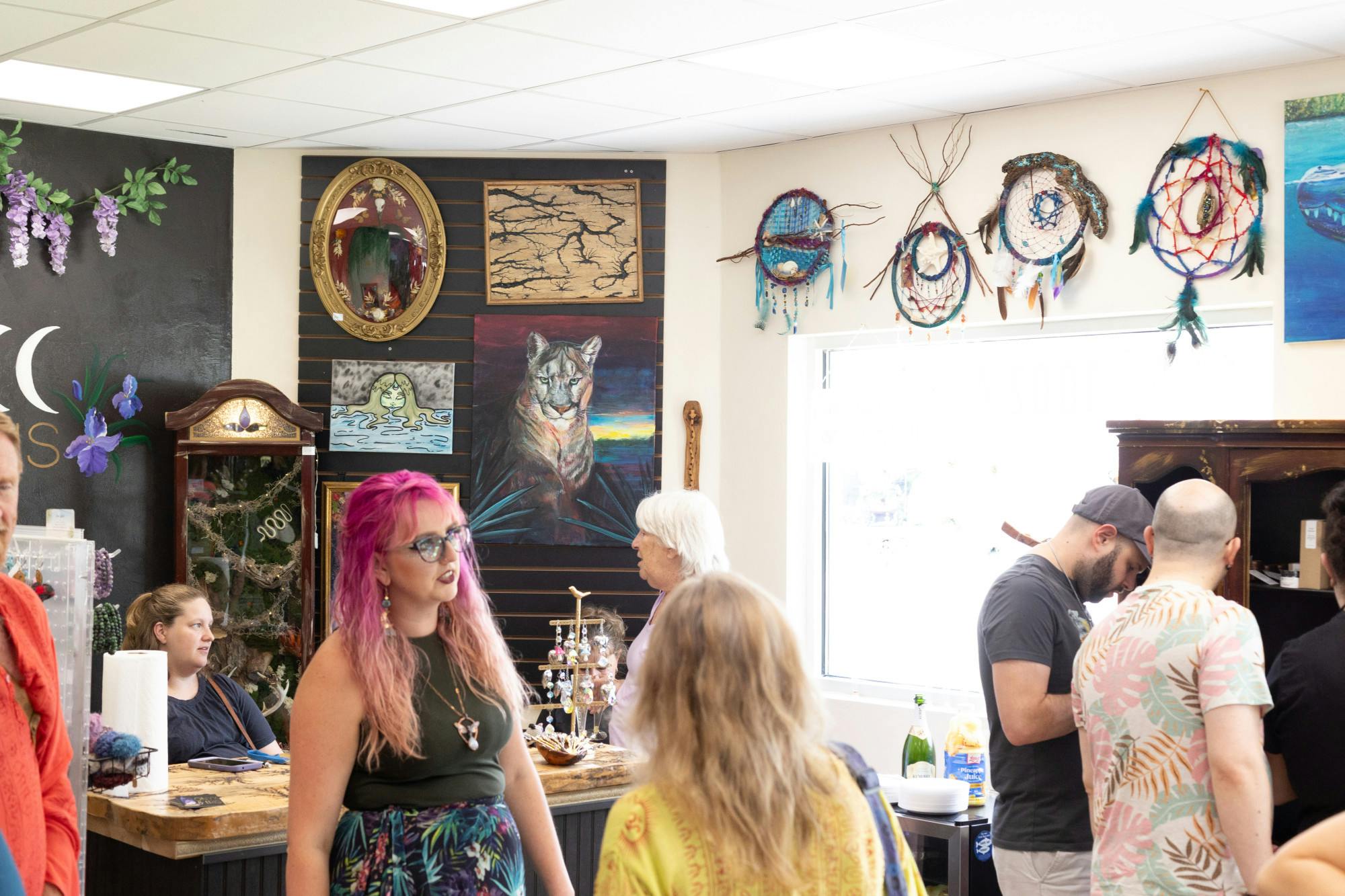 Guests converse during the opening of Onyx and Iris on Saturday, July 6, 2024.