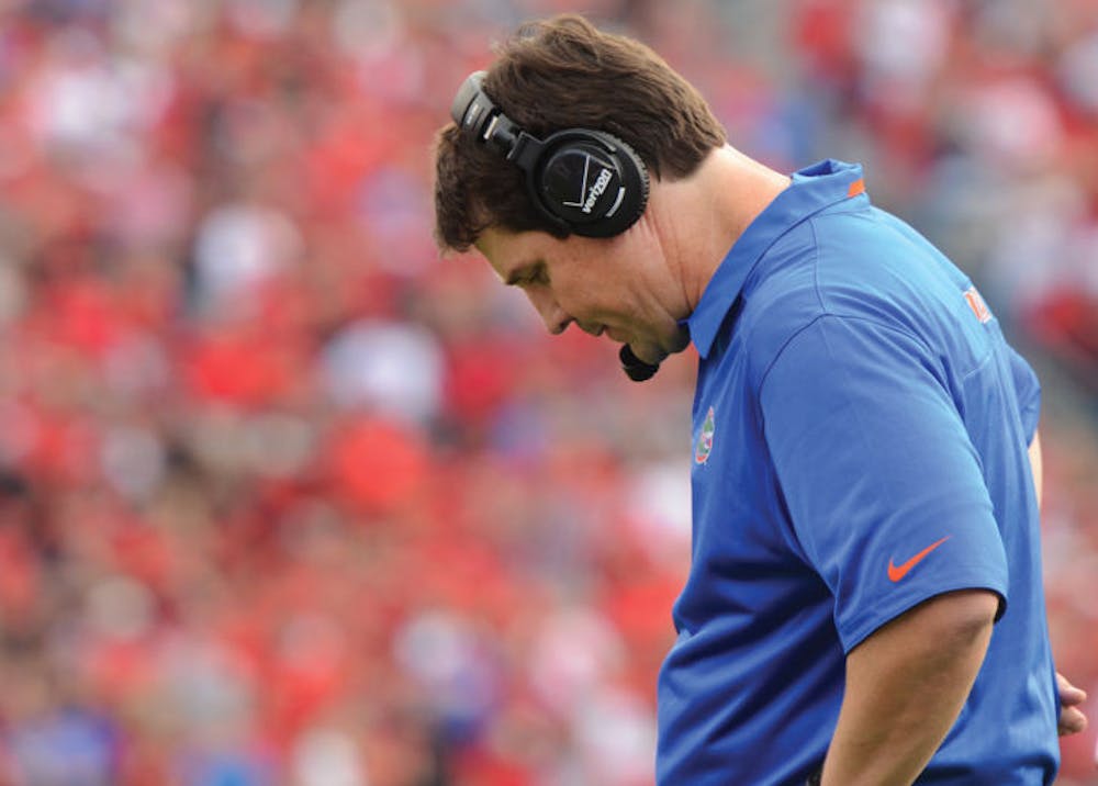 <p>Coach Will Muschamp looks down during Florida’s 23-20 loss to Georgia on Saturday at EverBank Field in Jacksonville. The Gators have lost three consecutive games against the Bulldogs.</p>