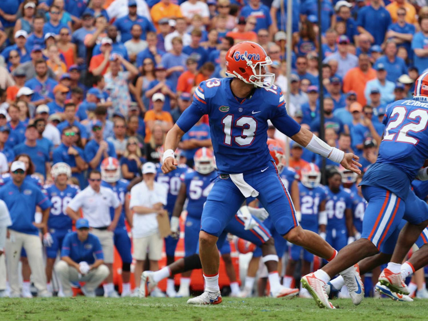 Feleipe Franks hands off the ball to Lamical Perine during Florida's 26-20 win against Tennessee on Saturday at Ben Hill Griffin Stadium.