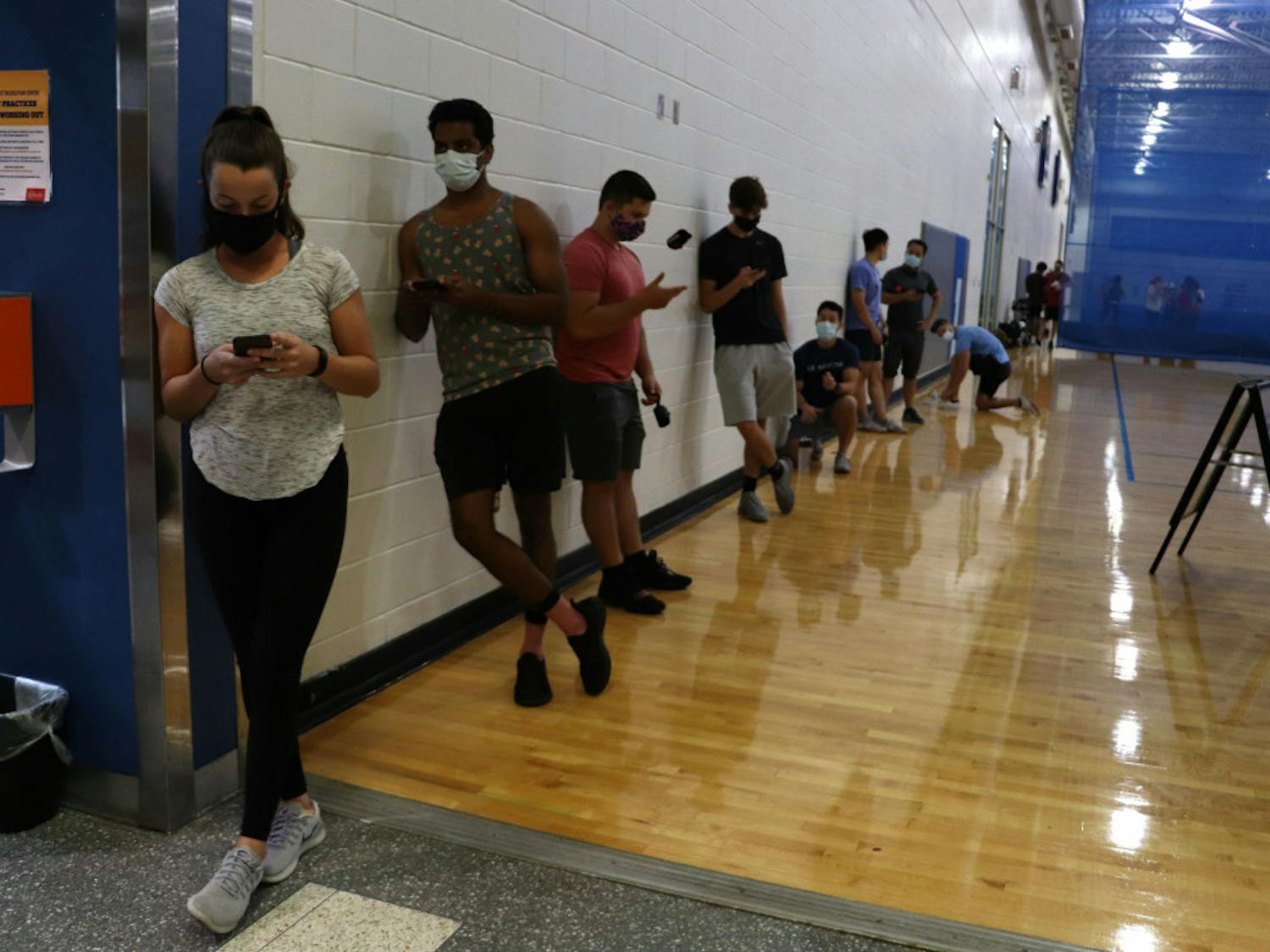 People stand in line to enter the weight room at the Southwest Recreation Center in Gainesville on Monday night, Sept. 21, 2020. According to recsports.ufl.edu, the weight room is open at limited capacity, however the website does not state how many people are allowed at one time.