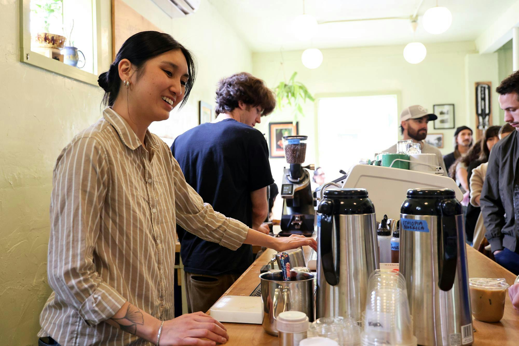 Vivi Lowery, co-owner of Lowbar greets a customer at Bushel and Peck and Lowbar in Gainesville, Fla., Saturday, Jan. 24, 2026.