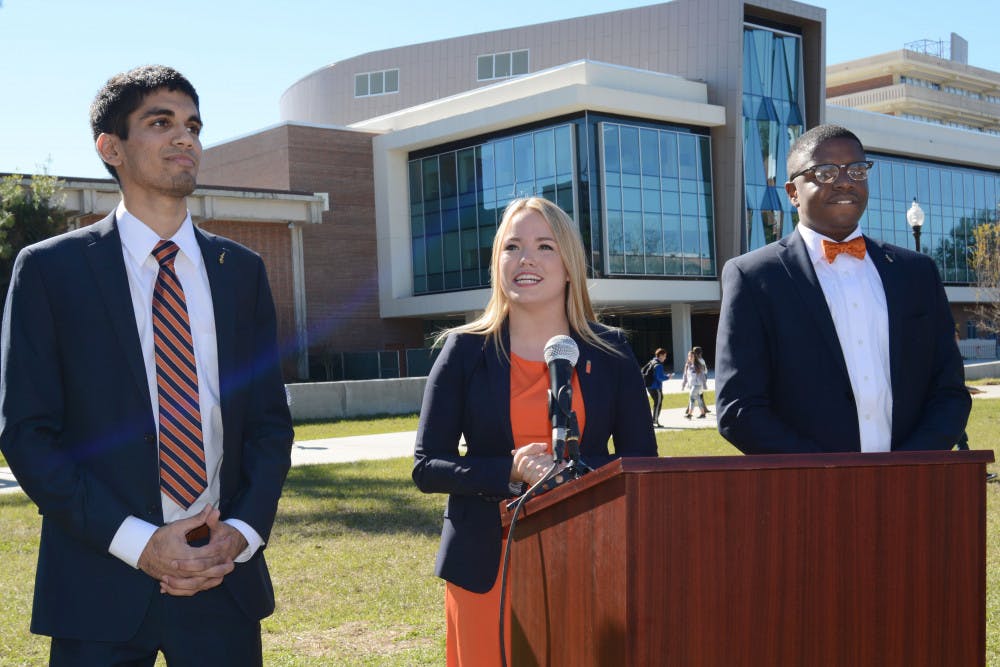 From left, Impact Party student body treasurer candidate Kishan Patel, 20, Impact Party student body president candidate Susan Webster, 22, and Impact Party student body vice-president candidate Brendon Jonassaint, 21, announce their candidacy to a crowd of students on the Reitz Union North Lawn on Jan. 20, 2016.