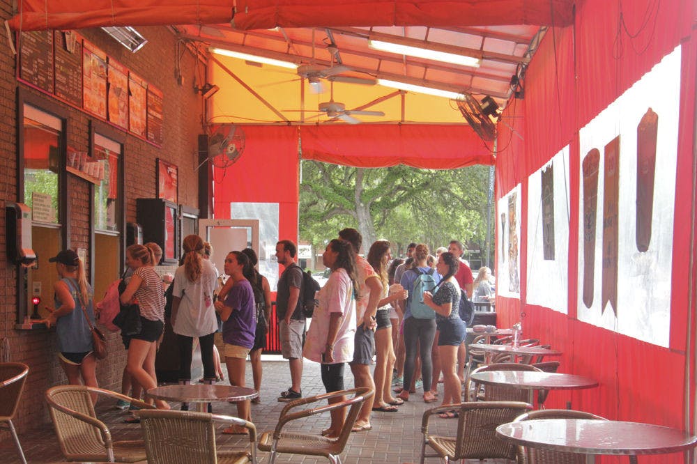 Customers wait in line for free coffee at the Dunkin’ Donuts at 1730 W. University Ave. around 4:45 p.m. on Sept. 29, 2015. About 35 were there, forming a line that stretched down the sidewalk outside.