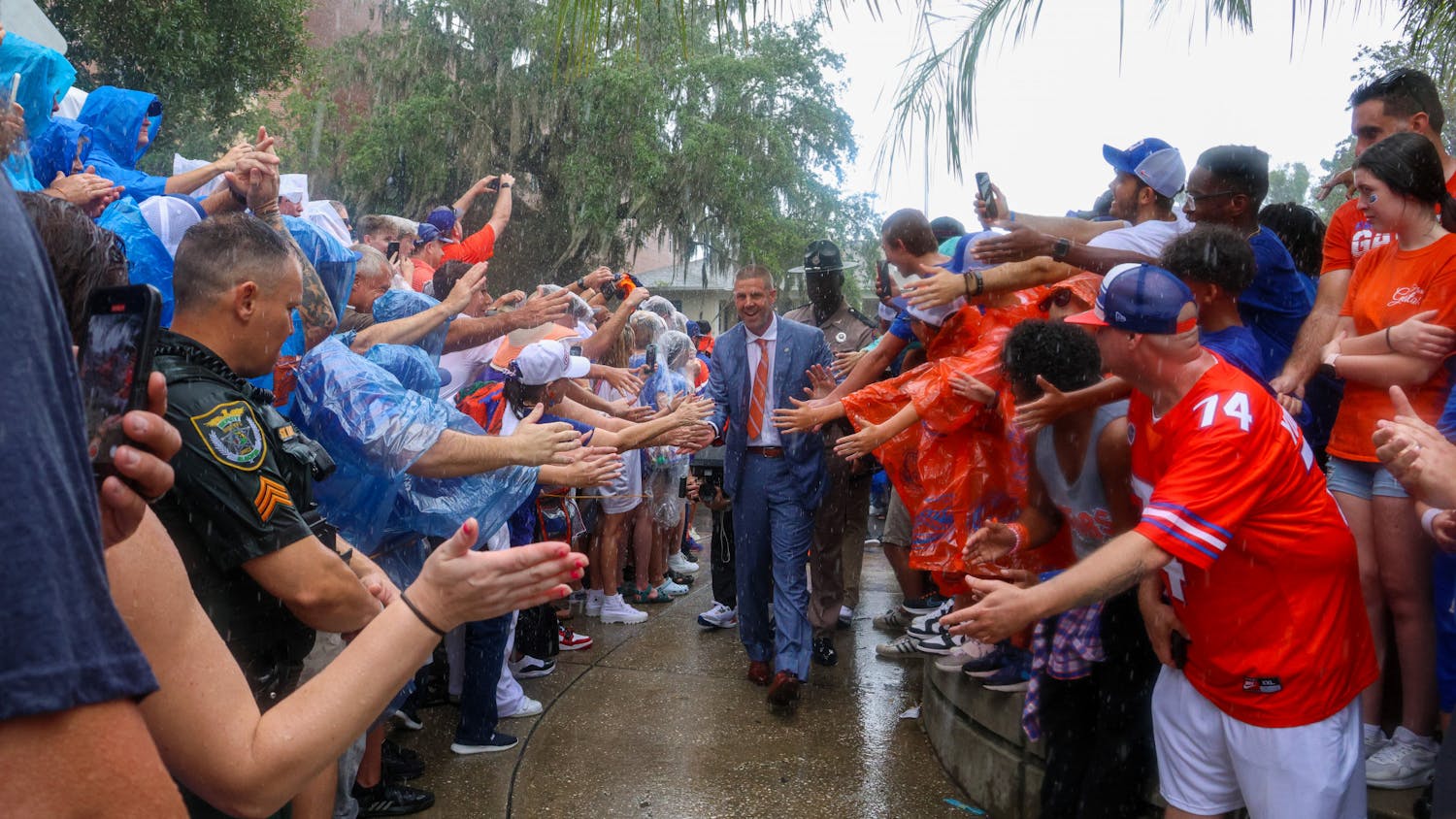 Coach Billy Napier walks through a crowd of fans during Gator Walk Saturday, Sept. 3, 2022.