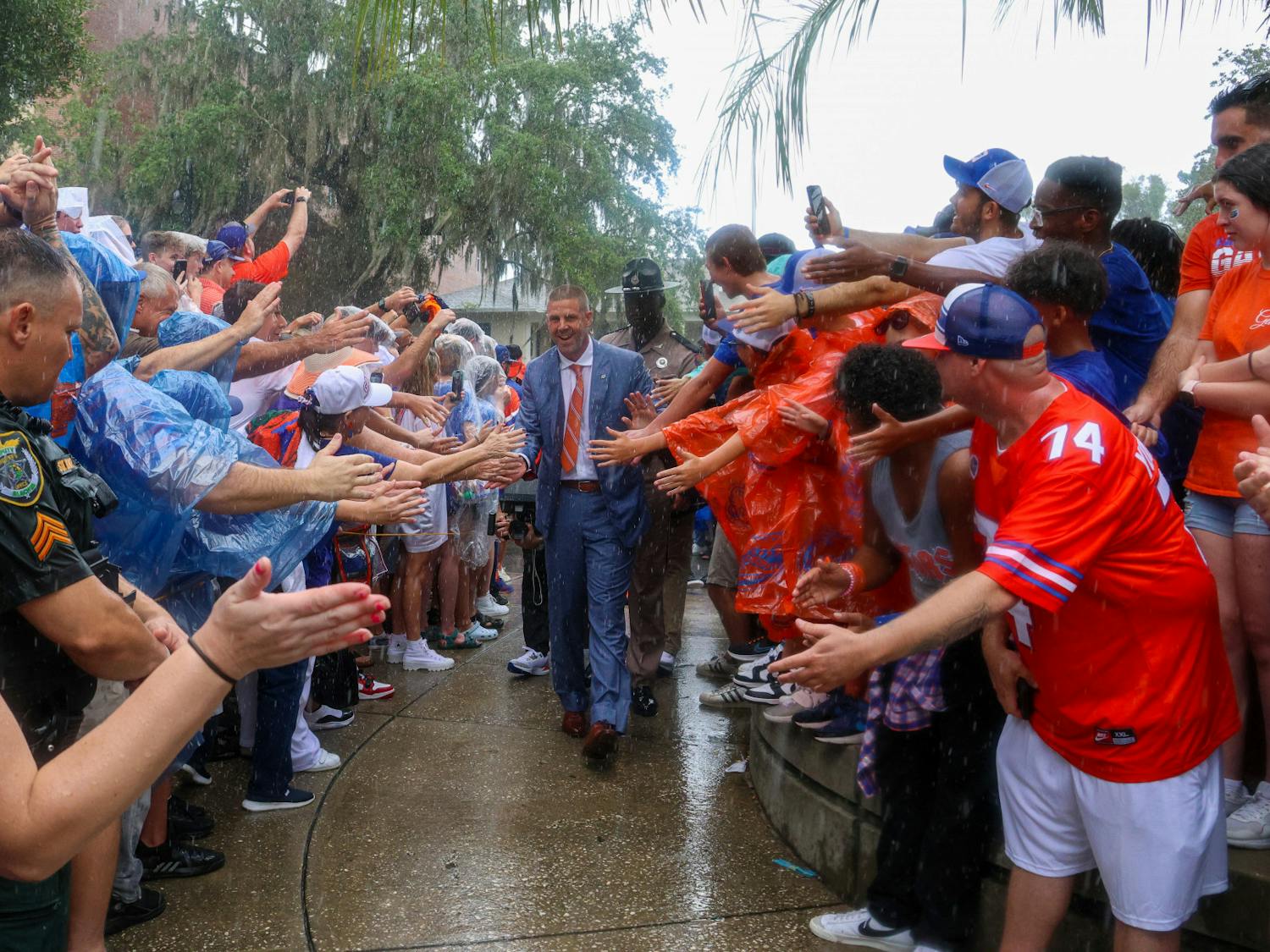 Coach Billy Napier walks through a crowd of fans during Gator Walk Saturday, Sept. 3, 2022.