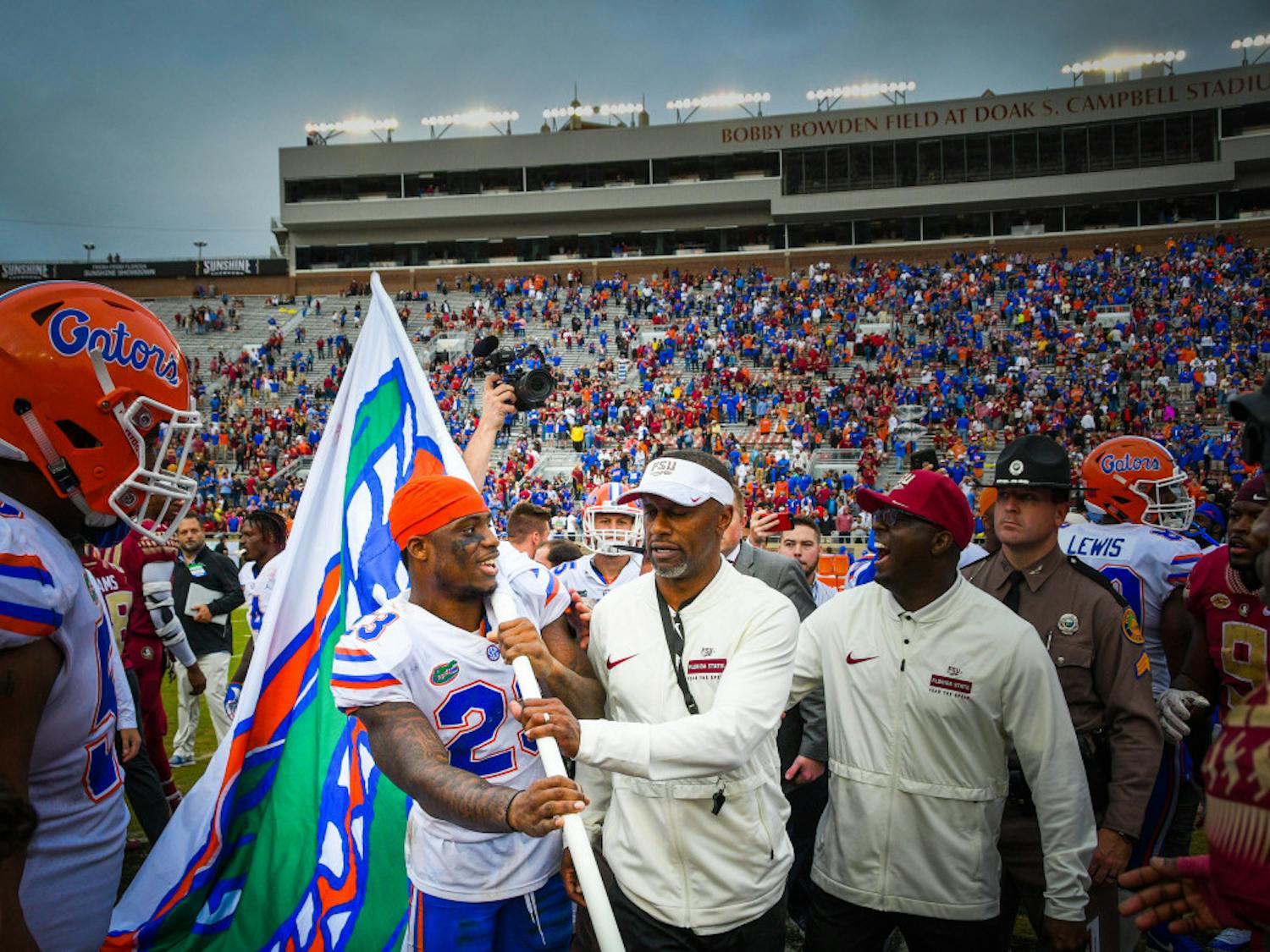 Florida State coach Willie Taggart stops Florida safety Chauncey Gardner-Johnson from planting a UF flag at midfield following the Gators’ 41-14 win over the Seminoles at Doak Campbell Stadium on Saturday. 