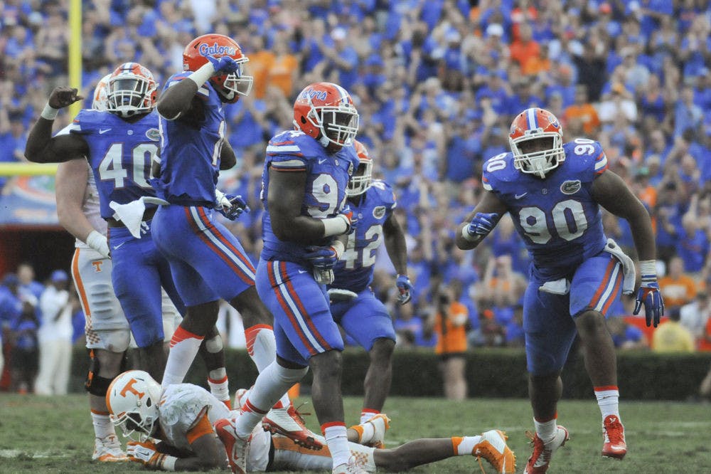 <p>UF linebacker Jarrad Davis (40, from left) and defensive linemen Alex McCalister, Bryan Cox Jr. and Jonathan Bullard celebrate after a sack during Florida's 28-27 win against Tennessee on Sept. 26, 2015, at Ben Hill Griffin Stadium.</p>