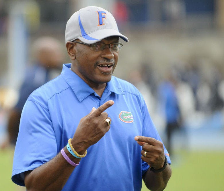 UF coach Mike Holloway smiles as he talks with his team during the 2016 Florida Relays at Percy Beard Track.