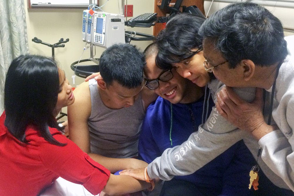 From left: Mara Abeleda, 25, Chris Abeleda, 21, CJ Abeleda, 24, Chris’ mother Victoria Abeleda, and father Charlie Abeleda, embrace the morning before CJ undergoes bone marrow donation surgery.