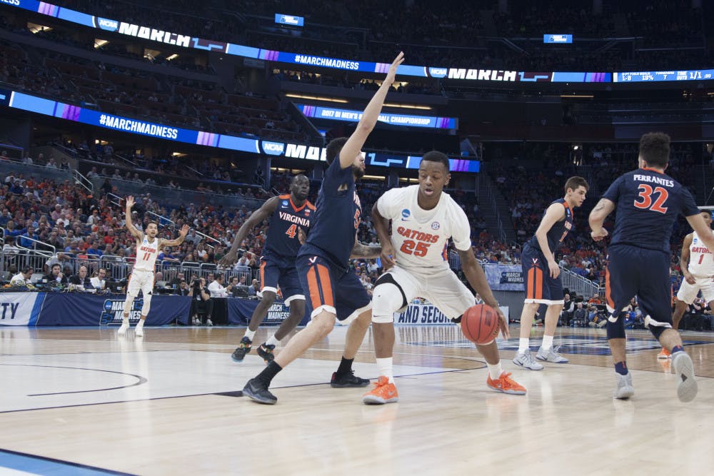 <p>Keith Stone dribbles towards the basket during Florida's 65-39 second-round win against Virginia in the NCAA Tournament on March 18, 2017.</p>