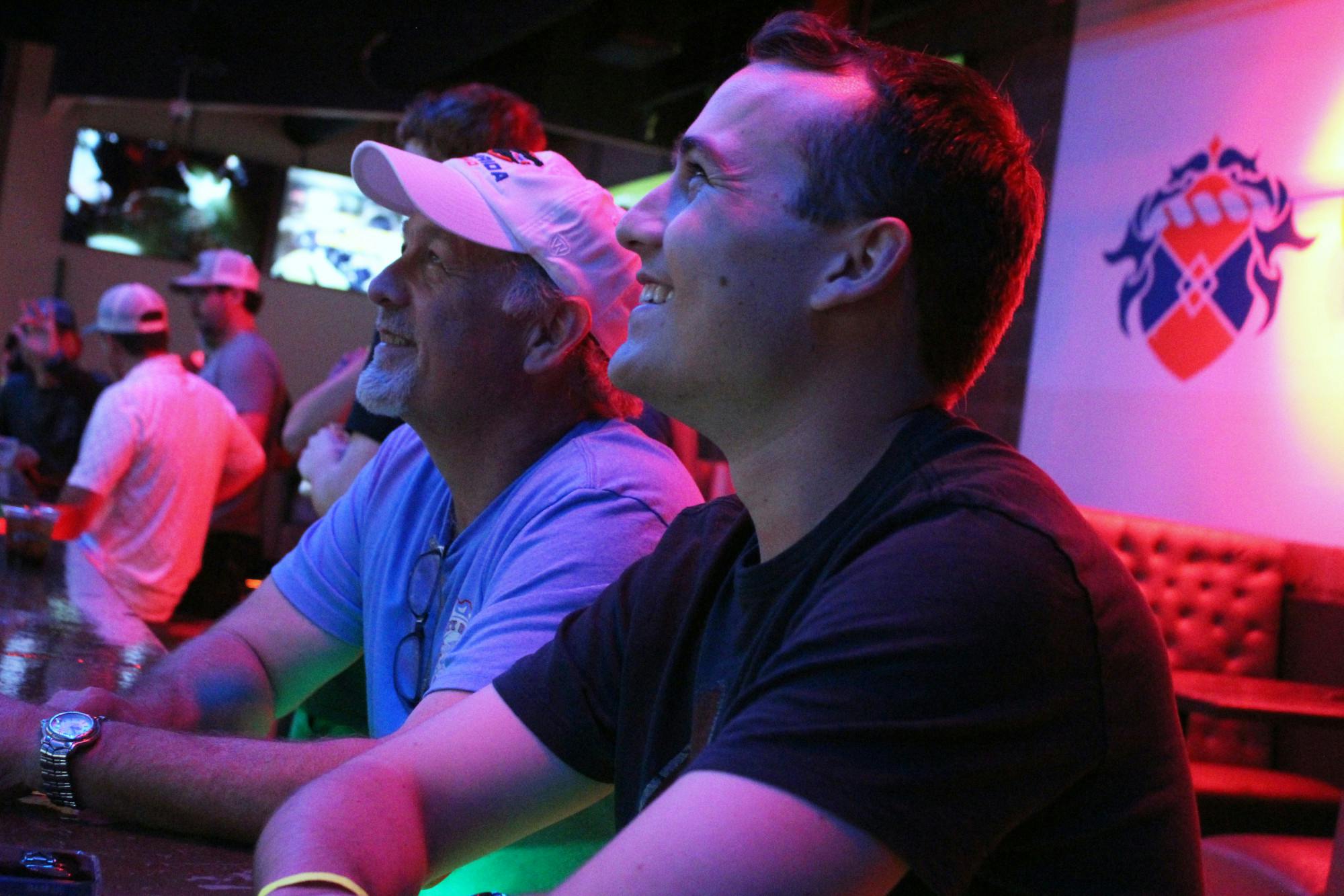 Ken Hagan (left) and his son, Jake Hagan (right), enjoy graduation night at MacDinton's on Friday, on August 8, 2025. 