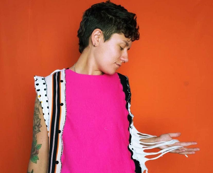 Kayla Burnett wears one of their custom clothing items. Burnett hopes to create a safe space for LGBTQ and non-binary individuals by providing the freedom to explore their identity through art.